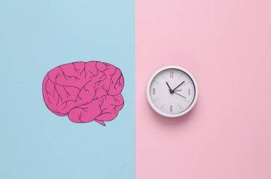 Paper-cut human brain with clock on pink blue background