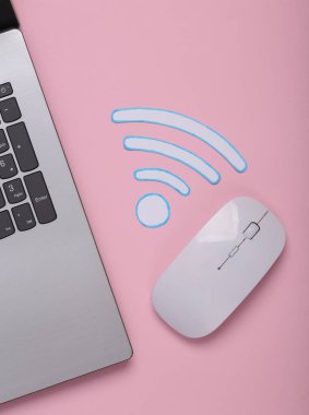 Kağıt kesiği Wi-Fi ikonu ve dizüstü bilgisayar, pembe arka planda bilgisayar faresi. Üst görünüm
