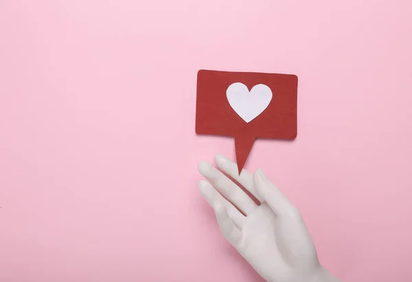 Hand Mit Ähnlichem Benachrichtigungssymbol Auf Rosa Hintergrund Soziale Medien Bewertung — Stockfoto