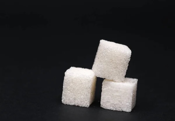 Três Cubos Açúcar Isolados Sobre Fundo Preto — Fotografia de Stock