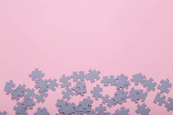 Puzzle pieces on a pink background. Top view. Mental health, business, concept. Copy space