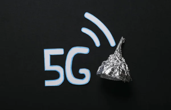 conspiracy theory. Foil hat and word 5G on a black background