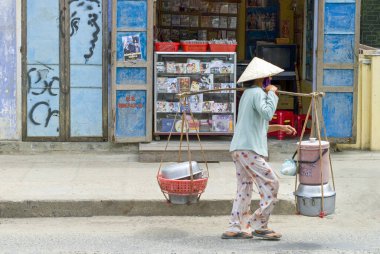Hoi An, Vietnam - May 28, 2008: A worker walking  in the old town
