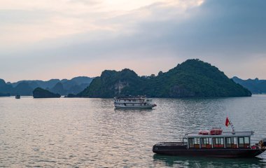 Halong, Vietnam,  boats for tourists between the islets and stacks of Halong Bay