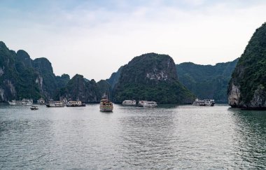 Halong, Vietnam,  boats for tourists between the islets and stacks of Halong Bay