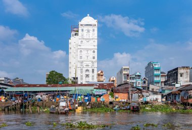 Cai Rang, Vietnam - November 25, 2019: The typical narrow vertical condominiums and the shacks on stilts seen from the Mecong river