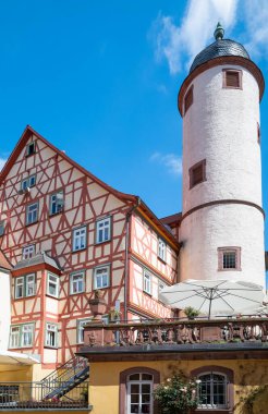Germany, Wertheim, upwward view of the medieval White Tower and a traditional half-timbered house