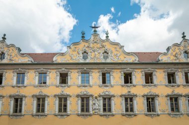 Germany, Wurzburg, upward view of the ancient rococo stucco decorated facade of the Falkenhouse