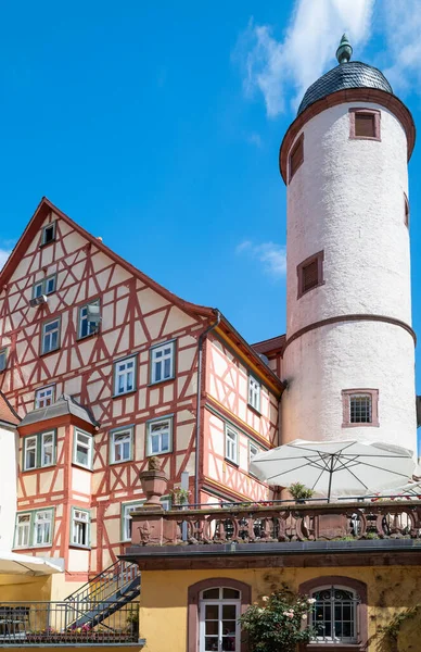 Germany, Wertheim, upwward view of the medieval White Tower and a traditional half-timbered house