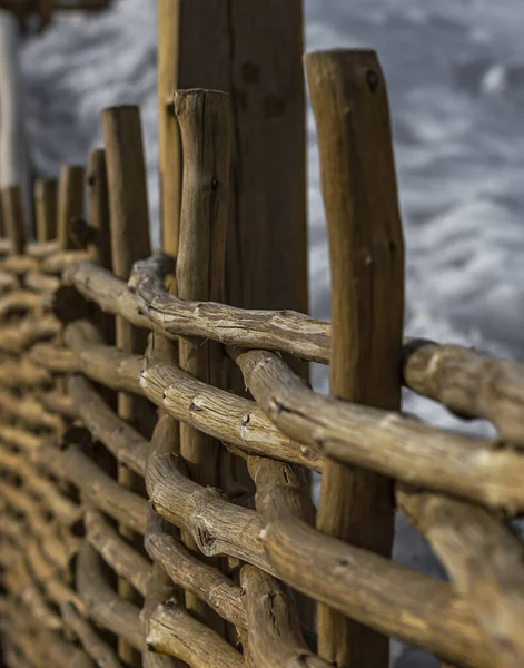 Eski ahşaptan yapılmış çit. Hasır ahşap çitler. Birbirine dolanmış dallardan yapılmış bir çit..