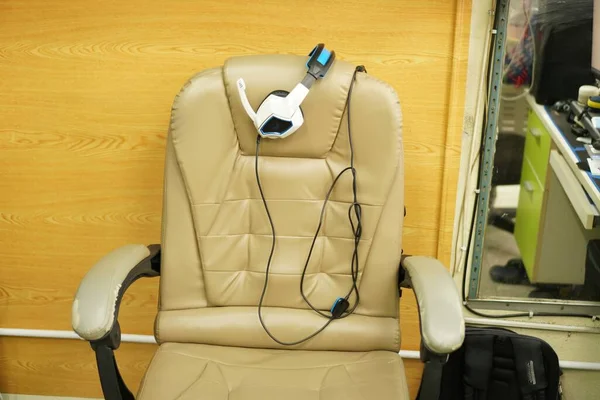 E-sports equipment: Gaming chair and Gamming headphones, close-up.