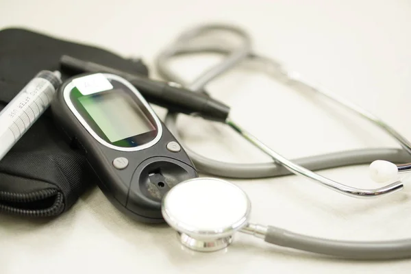 Medical: Stethoscope and blood sugar monitor, diabetes monitor.