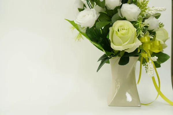 Picture of a bouquet of paper flowers in a vase for room decoration on a white background, isolated, close up.