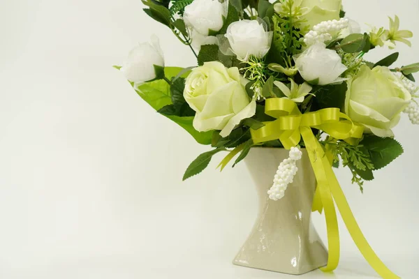 Picture of a bouquet of paper flowers in a vase for room decoration on a white background, isolated, close up.