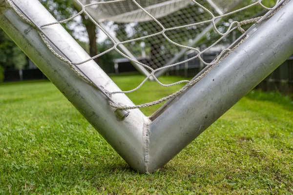 close-up of the corner of a soocer gold. silver steel and white net