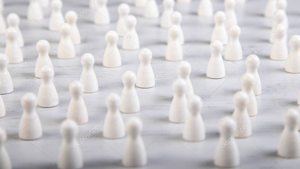 large group of white wooden figurines on a board