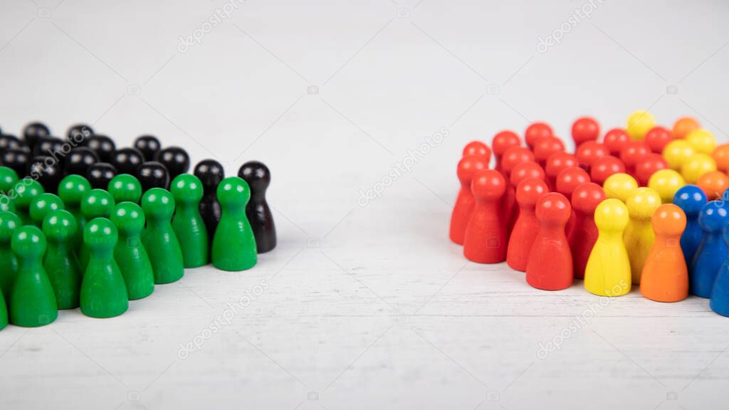 wooden figurines in the colors of German political parties, Green Party and Christian Democratic Union as government coalition and other parties as opposition