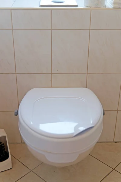 Help for people with disabilities: toilet with booster seat