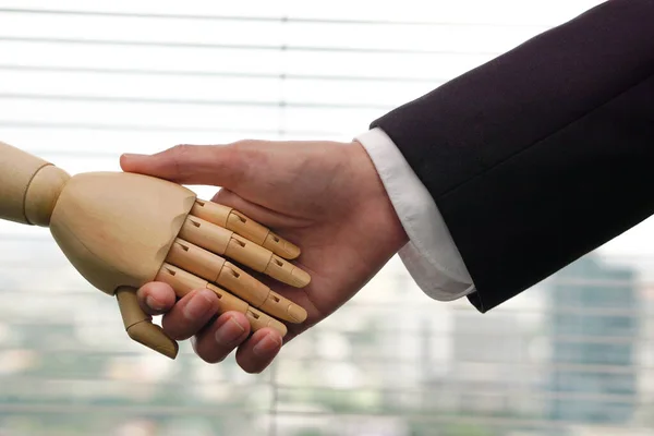 Robot Shaking hands with businessman. Artificial intelligence and technology future concept.
