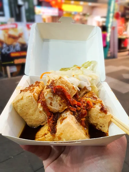 deep fry stinky tofu in takeout food box with soy souce and pickles