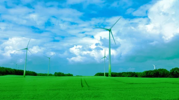 Ecological electric energy windmills in meadow, green field and blue sky