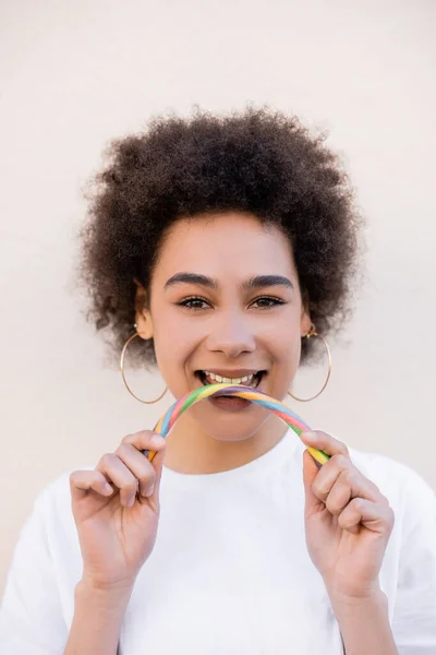 Happy African American Young Woman Hoop Earrings Eating Jelly Candy — Foto Stock