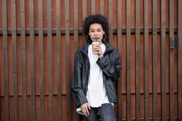 Young African American Woman Drinking Takeaway Beverage Straw Moustache Fence — Fotografia de Stock