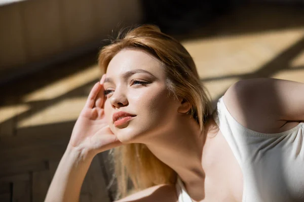 Retrato de una mujer joven y bonita mirando a su casa - foto de stock