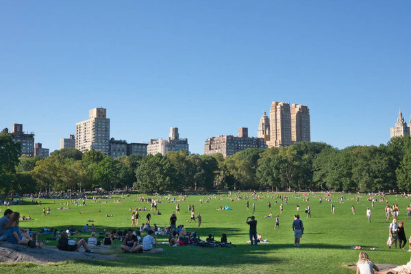 NEW YORK - CIRCA SEPTEMBER, 2017: People enjoy the summer comeback at Central Park