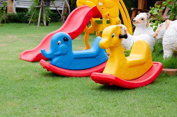 Colorful Plastic Rocking Horse Playground Lay Green Grass Background — Stok fotoğraf