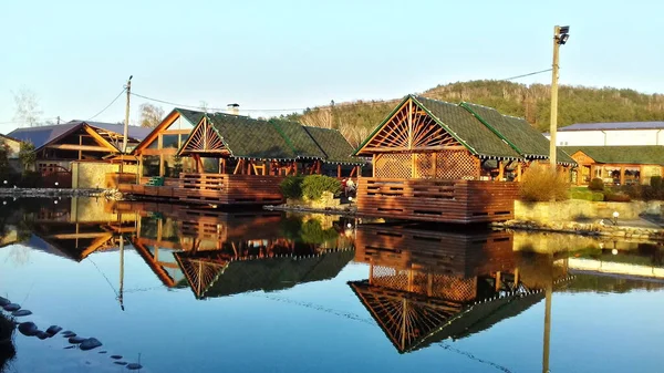wooden houses and reflection in water
