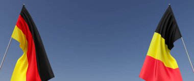 Bayrak direğinde Almanya ve Belçika bayrakları var. Mavi arka planda bayraklar. Mesaj için yer. Berlin, Münih. Brüksel, Avrupa. Bağımsız Devletler. 3B illüstrasyon.