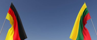 Mavi arka planda bayrak direkleri üzerinde Almanya ve Litvanya bayrakları. Mesaj için yer. Rüzgarda dalgalanan bayraklar. Alman, Berlin. Baltık, Vilnius. 3d illüstrasyon.