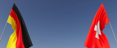 Mavi arka planda bayrak direkleri üzerinde Almanya ve İsviçre bayrakları. Mesaj için yer. Rüzgarda dalgalanan bayraklar. Alman, Berlin. İsviçre, Cenevre. 3d illüstrasyon.