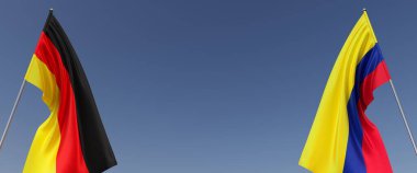 Mavi arka planda bayrak direkleri üzerinde Almanya ve Kolombiya bayrakları. Mesaj için yer. Rüzgarda dalgalanan bayraklar. Alman, Berlin. Bogota. 3d illüstrasyon.