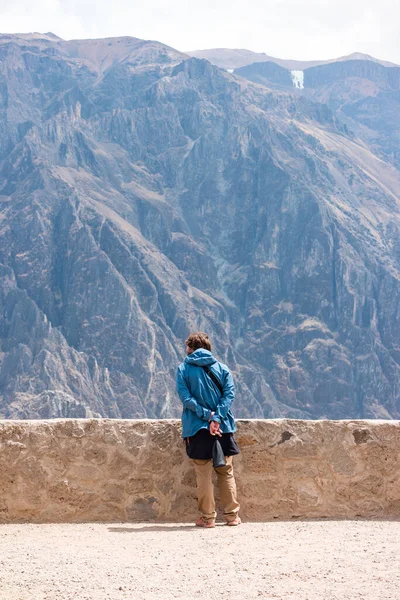 A tourist looks at the world\'s deepest canyon Colca in Peru.