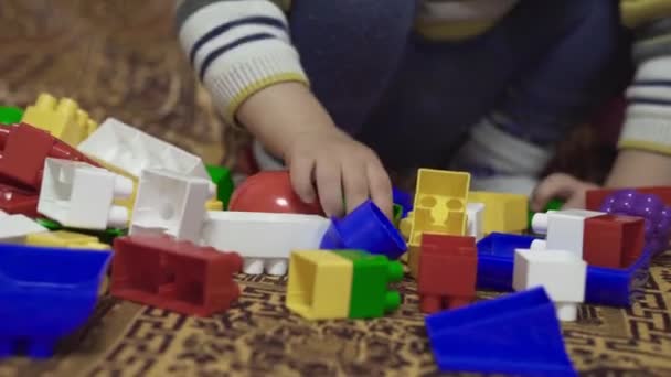Gyereket Játékokkal Játsszák Kisfiú Összeszereli Kivitelezőt Ágyon Sokszínű Játékszerek Apró — Stock videók