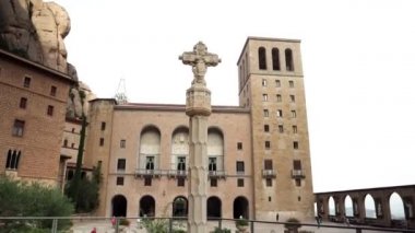 İspanya 'daki Montserrat Dağı. Montserrat 'ın ünlü manastırı. Benedikt rahiplerinin dağ inzivası. Tırtıklı dağ. Turistler dağlardaki bir manastırı ziyaret ediyorlar.