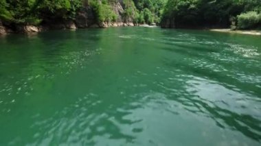 Matka Üsküp Kanyonu. Kuzey Makedonya 'daki kanyon. Treska Nehri Vadisi. Tekne gezisi. Yeşil kayalık yamaçlar. Şeffaf Matka Gölü ve turkuaz su. Kanyonun panoramik görüntüsü