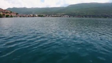 Picturesque view from the lake to Ohrid. City of Ohrid in North Macedonia. A city on the eastern shore of Lake Ohrid. Green mountains of North Macedonia. The deepest and oldest lake in the Balkans
