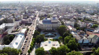 View from the drone Odessa National Academic Opera and Ballet Theater. One of the largest theaters in Ukraine. People are resting near the fountain of the Odessa Opera and Ballet Theater. Odessa drone