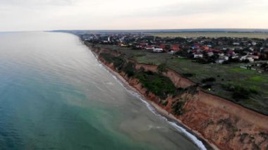 Aerial view of Sanzheyka village, Odessa region. Shot from a drone resort on the Black Sea, the village of Sanzheyka. Place of wild rest in Odessa. Clay cliff on the Black Sea coast in Odessa.