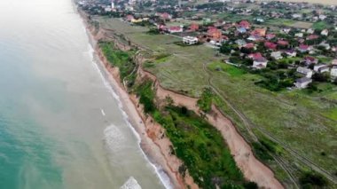 Aerial view of Sanzheyka village, Odessa region. Shot from a drone resort on the Black Sea, the village of Sanzheyka. Place of wild rest in Odessa. Clay cliff on the Black Sea coast in Odessa.