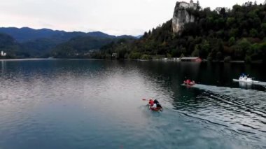 A shot from a drone of a rowing competition. Bled Castle. Drone view of Lake Bled in Slovenia. A cliff-top castle at Lake Blaysko near the town of Bled. Slovenia's old castle. Boat competition