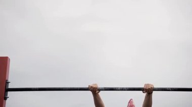 Workout sports competitions inNorthern Europe.Young athletes show acrobatic stunts on the crossbar. Street training of athletes on bars and horizontal bars. Gymnastics