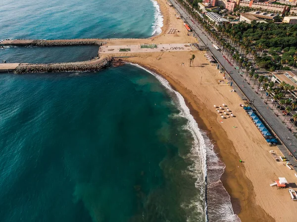 Drone shot Barcelona. Drone view of a vibrant swimming and sunbathing beach in Barcelona. People are relaxing on the beach. Panoramic view of the city of Barcelona. Spain from drone.