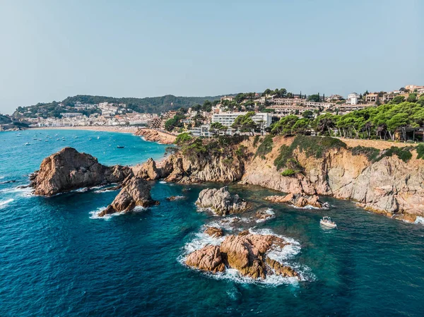 Drone view of rocky cliffs and the sea in the city of Tossa de Mar. Drone shot of a municipality in Spain. The resort town of Tossa de Mar near the Mediterranean Sea. Drone shot Tossa de Mar