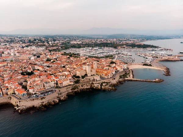 Drone shot of the old city of Antibes. Cote d'Azur of the Mediterranean Sea of France. Resort on the French Riviera Antibes. Picasso Museum. View from the drone yachts moored in the city marina.