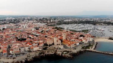 Drone shot of the old city of Antibes. Cote d'Azur of the Mediterranean Sea of France. Resort on the French Riviera Antibes. Picasso Museum. View from the drone yachts moored in the city marina.
