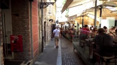 Restaurants and cafes in the city of Zagreb. Pedestrian areas with cozy cafes decorated with flowers and terraces. People eat at a terrace restaurant in Zagreb, Croatia.